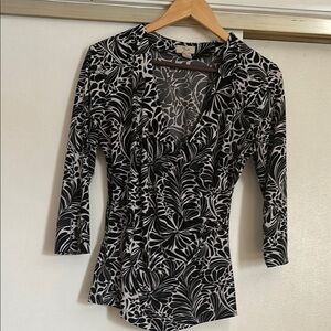 Black floral print blouse with deep V-neckline and three-quarter sleeves